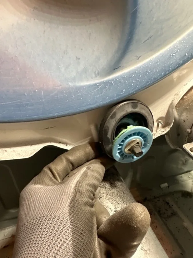Dryer drum roller replacement during dryer repair service