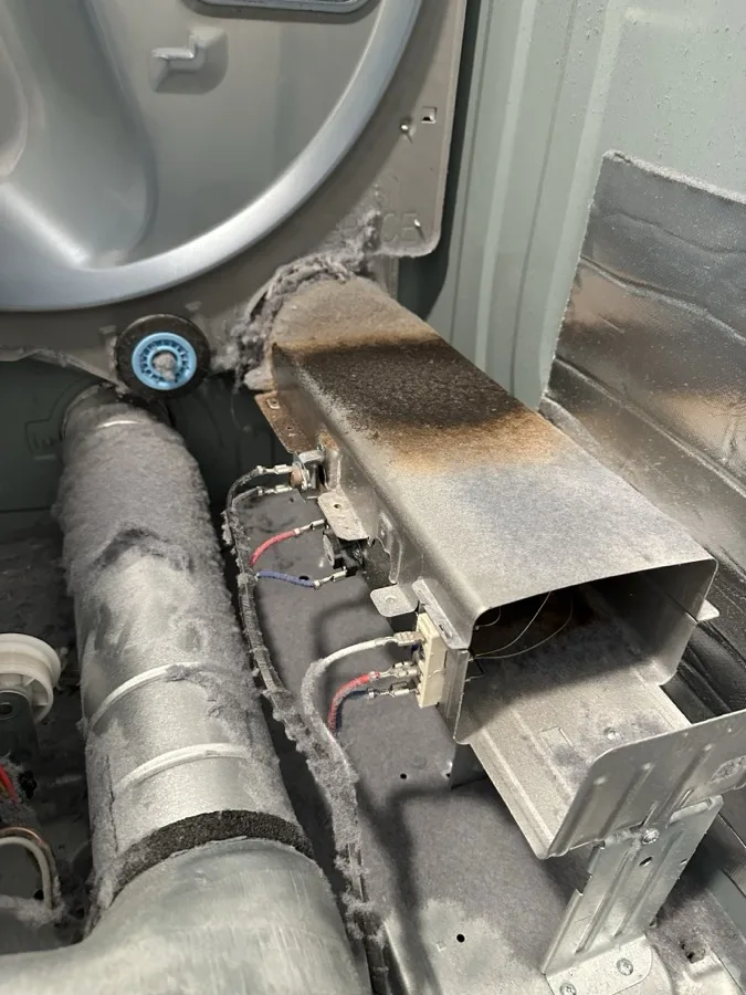 Dryer overheating repair with heating element housing exposed during service